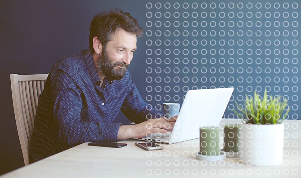 a man uses his laptop at a table