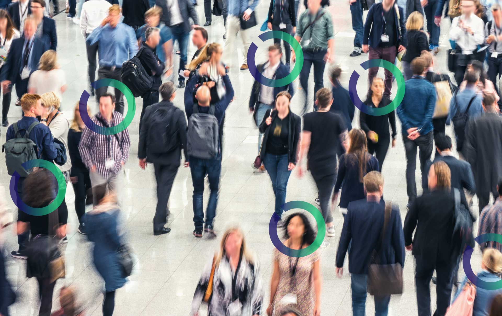 A crowd of people walking on the sidewalk. Some have Outseer logo circles around their faces to represent facial recognition.